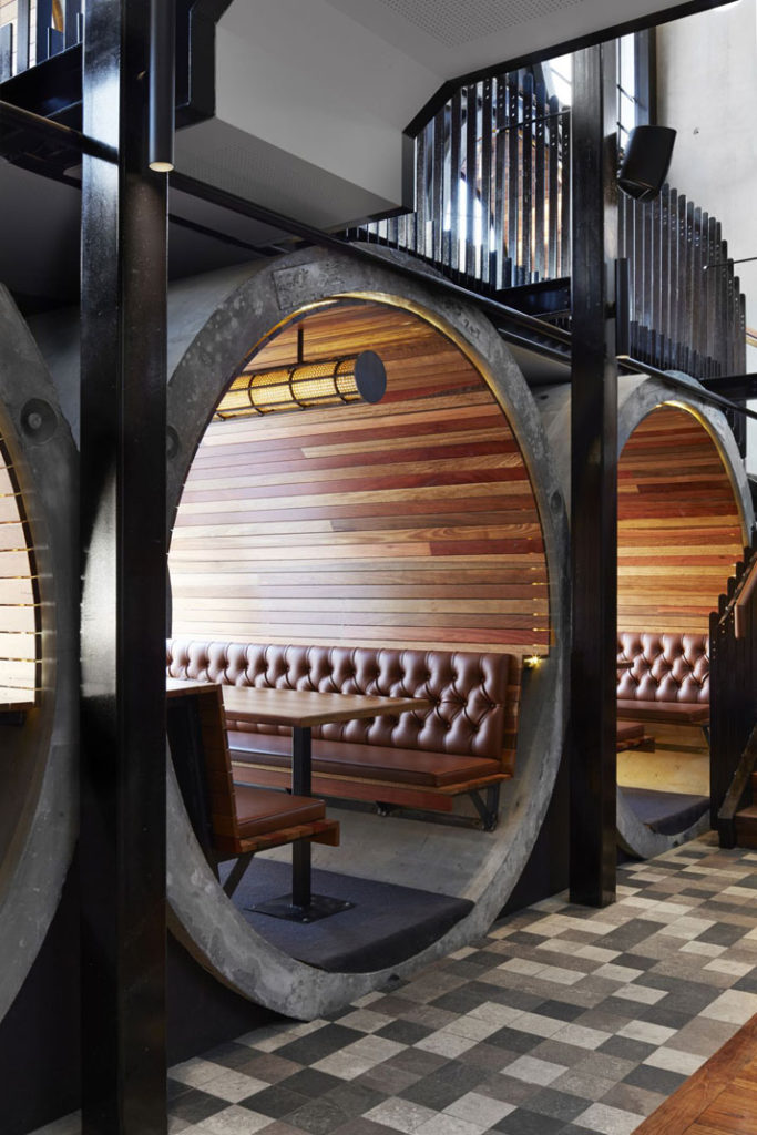 I love a good restaurant booth and this one from the Prahran Hotel in Melbourne, Australia is about as cool as it gets.  Inside a giant re-used concrete pipe, this design wins on many levels.